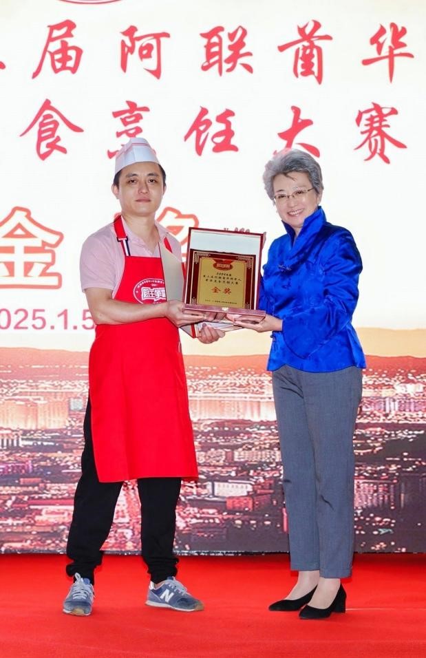 中国驻迪拜总领事欧渤芊(右)为金奖获得者颁奖。主办方供图 中国驻迪拜总领事欧渤芊(右)为金奖获得者颁奖。主办方供图