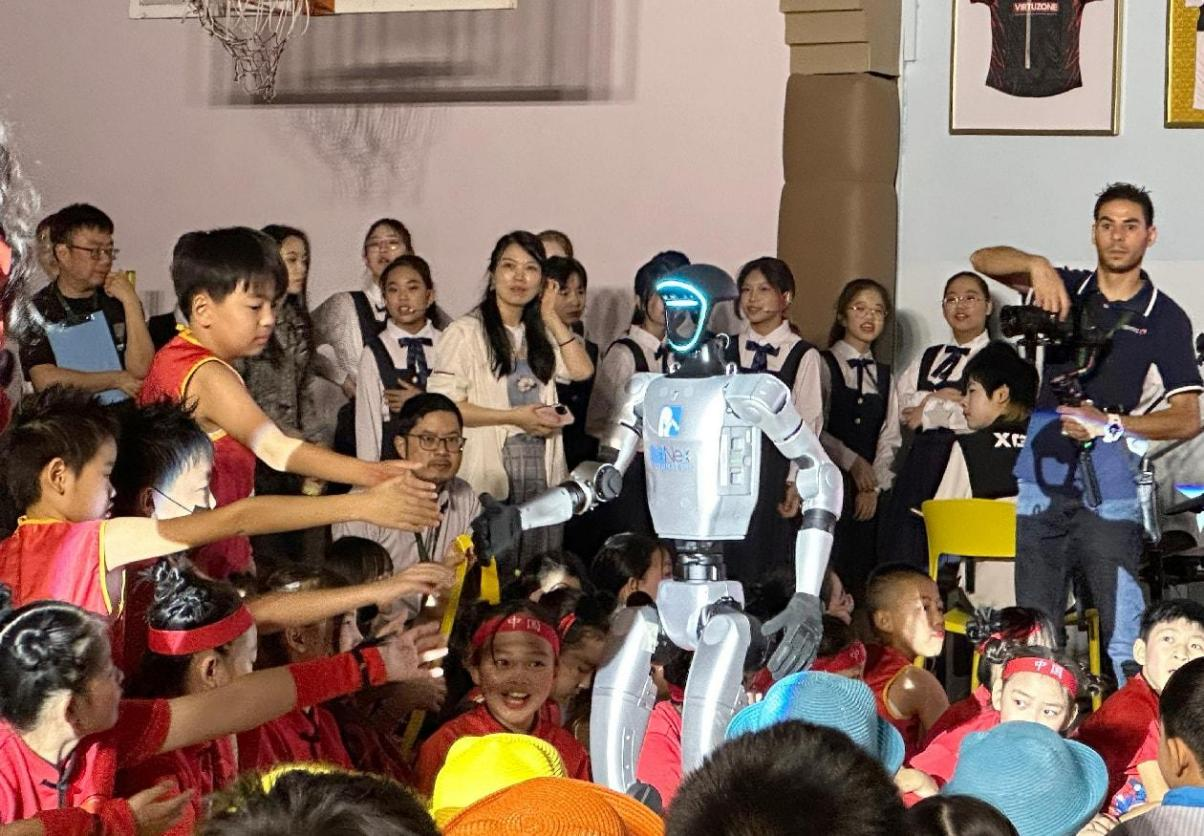 孩子们争相同机器人握手。迪拜中国学校供图 孩子们争相同机器人握手。迪拜中国学校供图