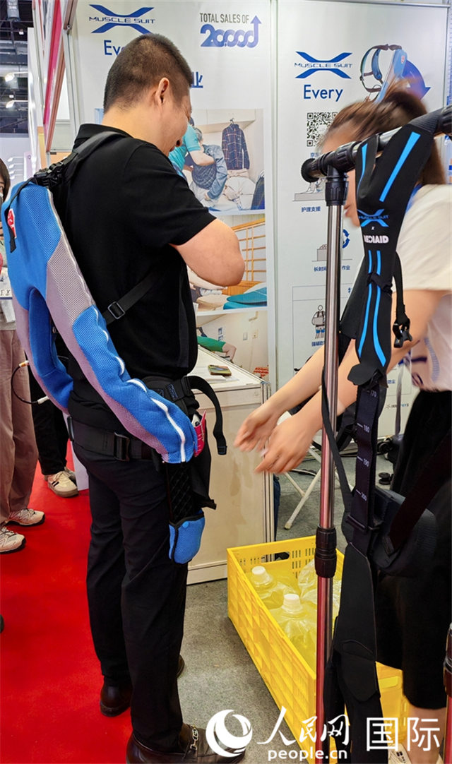 一名参展者在现场试穿“肌力服”。人民网记者 张靖摄 一名参展者在现场试穿“肌力服”。人民网记者 张靖摄