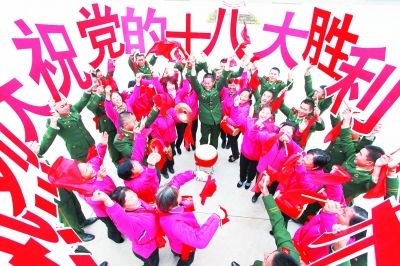 江苏镇江伯先社区的40名锣鼓队队员和边防官兵一起载歌载舞,欢庆党的十八大胜利召开。