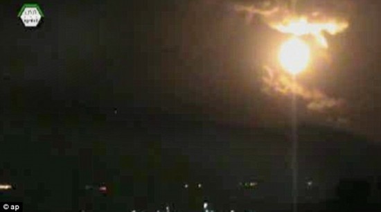 Lit up: The image from an authenticated video obtained from the Ugarit News shows the sky glowing from the explosions