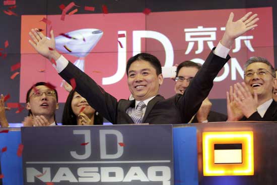 Qiangdong Liu, CEO of JD.com, raises his arms to celebrate the IPO for his company at the Nasdaq MarketSite, Thursday, May 22, 2014 in New York. 