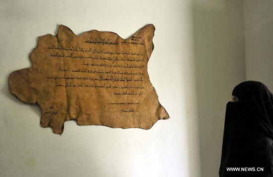 A Yemeni woman looks at restored manuscripts inside a repair center in Sanaa, Yemen, on June 2, 2014. Yemeni government began the restoration of the manuscripts in 1980. In the repair center, there are 16,000 ancient parchment fragments, some of which are among the oldest Quran manuscripts in the world. 