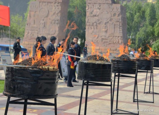 Drugs are burnt on International Day Against Drug Abuse and Illicit Trafficking in Qamdo, southwest China's Tibet Autonomous Region, June 26, 2014.