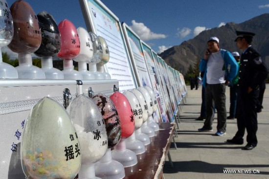 Drug samples are displayed in an anti-drug activity on International Day Against Drug Abuse and Illicit Trafficking in Lhasa, southwest China's Tibet Autonomous Region, June 26, 2014.