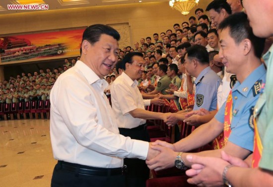 Senior Chinese leaders Xi Jinping, Li Keqiang and Zhang Gaoli meet with representatives attending a national meeting on frontier and coast defense in Beijing, China, June 27, 2014. 