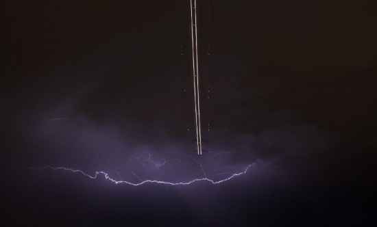 A jet aircraft takes off as lightning strikes across the sky during a monsoon storm at McCarran International Airport in Las Vegas, Nevada July 7, 2014. Picture taken July 7.