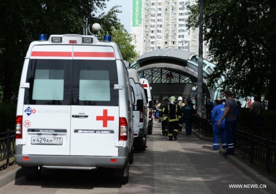 An ambulance parks outside the Slavyanski Bulvar subway station in Moscow, capital of Russia, on July 15, 2014. At least 16 people have been confirmed dead after a metro train derailed in Moscow during the morning rush hour on Tuesday, Russian Emergency Situations Minister Vladimir Puchkov said.