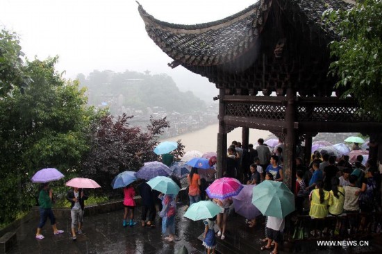 More than 120,000 locals and tourists have been evacuated since Monday night as record downpours hit Fenghuang County, a tourist destination renowned for its ancient town. 