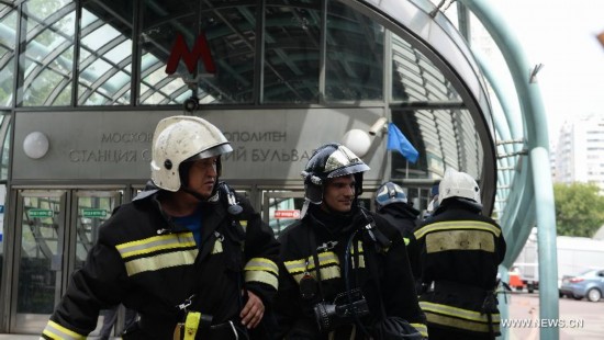 Rescuers and repair personnel work outside the Slavyanski Bulvar subway station in Moscow, capital of Russia, on July 15, 2014. At least 16 people have been confirmed dead after a metro train derailed in Moscow during the morning rush hour on Tuesday, Russian Emergency Situations Minister Vladimir Puchkov said.