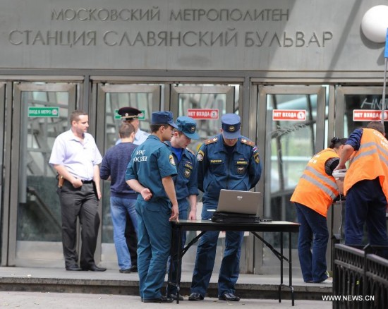 Rescuers and repair personnel work outside the Slavyanski Bulvar subway station in Moscow, capital of Russia, on July 15, 2014. At least 16 people have been confirmed dead after a metro train derailed in Moscow during the morning rush hour on Tuesday, Russian Emergency Situations Minister Vladimir Puchkov said.