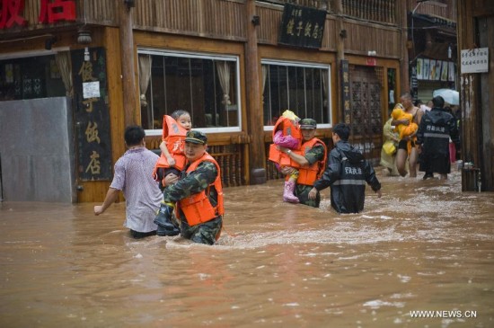 More than 120,000 locals and tourists have been evacuated since Monday night as record downpours hit Fenghuang County, a tourist destination renowned for its ancient town. 