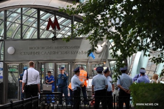 Rescuers and repair personnel work outside the Slavyanski Bulvar subway station in Moscow, capital of Russia, on July 15, 2014. At least 16 people have been confirmed dead after a metro train derailed in Moscow during the morning rush hour on Tuesday, Russian Emergency Situations Minister Vladimir Puchkov said.