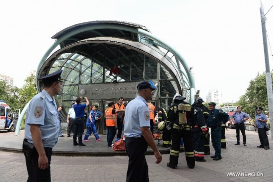 Rescuers and repair personnel work outside the Slavyanski Bulvar subway station in Moscow, capital of Russia, on July 15, 2014. At least 16 people have been confirmed dead after a metro train derailed in Moscow during the morning rush hour on Tuesday, Russian Emergency Situations Minister Vladimir Puchkov said.