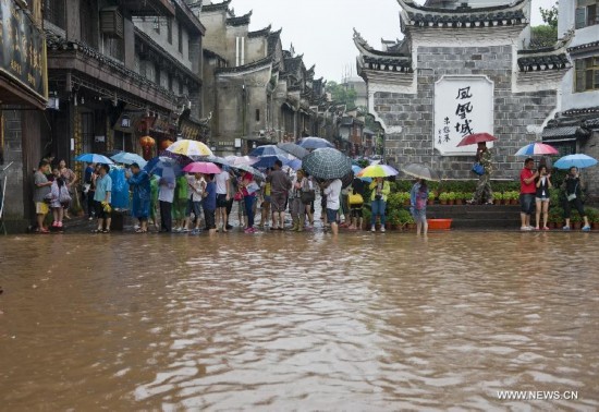 More than 120,000 locals and tourists have been evacuated since Monday night as record downpours hit Fenghuang County, a tourist destination renowned for its ancient town. 