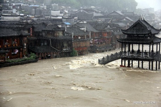 More than 120,000 locals and tourists have been evacuated since Monday night as record downpours hit Fenghuang County, a tourist destination renowned for its ancient town. 