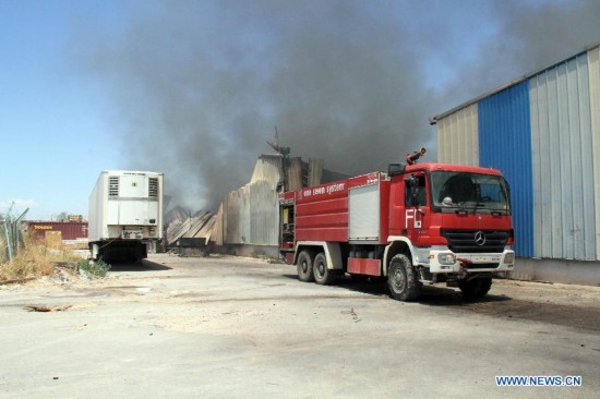 A firetruck parks beside a fire site in Tripoli International Airport, in Libya, on July 16, 2014. 