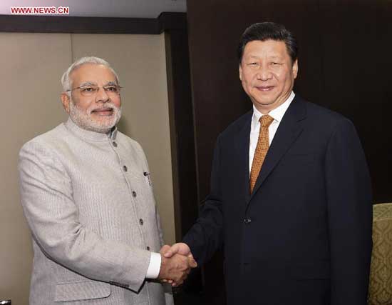 Chinese President Xi Jinping(R) meets with Indian Prime Minister Narendra Modi in Fortaleza, Brazil, July 14, 2014. (Xinhua/Li Xueren) 