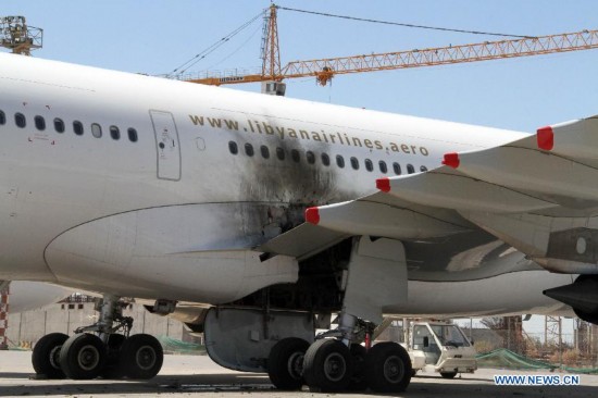 The photo taken on July 16, 2014 shows a damaged plane on the tarmac in Tripoli International Airport, in Libya. 