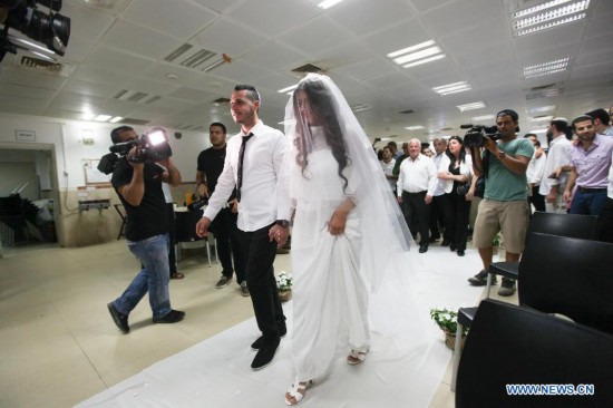 Israeli bride Zohar and her groom Haim are seen at their wedding party in a bomb shelter of the Yeshva (religious school) in Sderot, southern Israel bordering Gaza Strip, on July 16, 2014. 