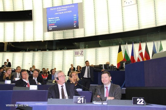 Jean-Claude Juncker (front L) waits for the result of the election at the European Parliament in Strasbourg, France, July 15, 2014. The European Parliament on Tuesday approved former Luxembourg Prime Minister Jean-Claude Juncker as European Commission President by an absolute majority.