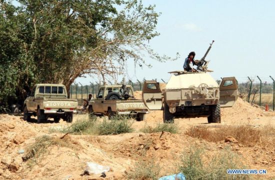 Militiamen stand guard the perimeter of Tripoli International Airport, in Libya, on July 16, 2014. 