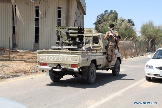 A militia takes a ride on an armed vehicle in Tripoli International Airport, in Libya, on July 16, 2014. 