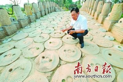7月17日,刘斯峨在用石磨铺成的道路上讲述他收集石磨的故事。
