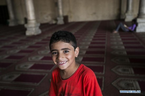 An Egyptian boy looks on inside a mosque during the fasting hours in a Ramadan afternoon in Cairo June 29, 2014.