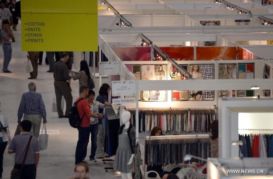 People visit the China Textile and Apparel Trade Show and the Home Textiles Fabric Sourcing Expo in New York, the United States, July 22, 2014.