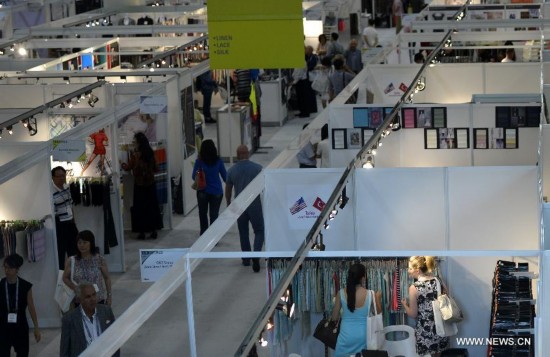 People visit the China Textile and Apparel Trade Show and the Home Textiles Fabric Sourcing Expo in New York, the United States, July 22, 2014.