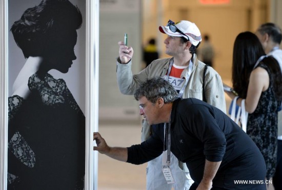 People visit the China Textile and Apparel Trade Show and the Home Textiles Fabric Sourcing Expo in New York, the United States, July 22, 2014. 