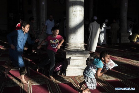 Egyptian boys have fun inside a mosque during their fasting hours in a Ramadan afternoon in Cairo July 22, 2014.