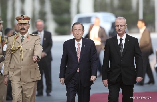 United Nations Secretary General Ban Ki-Moon (C) is welcomed by Palestinian Prime Minister Rami Hamdallah (R) in the west bank city of Ramallah on July 22, 2014. 