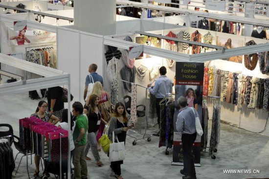 People visit the China Textile and Apparel Trade Show and the Home Textiles Fabric Sourcing Expo in New York, the United States, July 22, 2014.