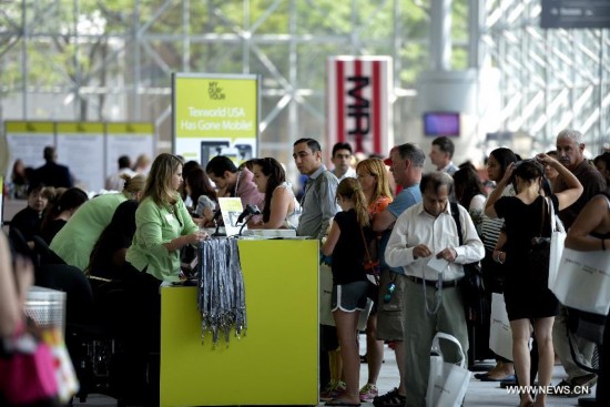 People visit the China Textile and Apparel Trade Show and the Home Textiles Fabric Sourcing Expo in New York, the United States, July 22, 2014. 
