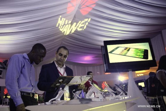 Visitors look at telecommunication products during Huawei's exhibition ICT in Panama City, capital of Panama, on July 29, 2014. 