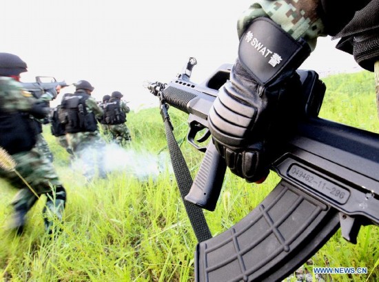 Armed policemen of the third detachment of Shanghai Armed Police Corps take part in a combat exercises in Shanghai, east China, July 30, 2014.