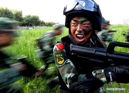 Armed policemen of the third detachment of Shanghai Armed Police Corps take part in a combat exercises in Shanghai, east China, July 30, 2014.