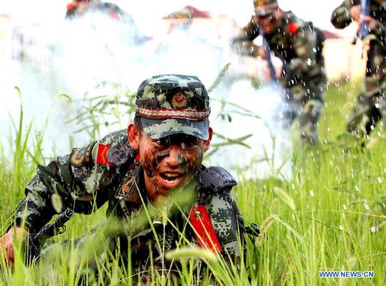 Armed policemen of the third detachment of Shanghai Armed Police Corps take part in a combat exercises in Shanghai, east China, July 30, 2014.