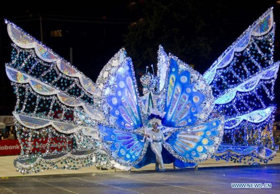 A dressed up competitor perfroms with her float during the King and Queen Competition and Show of the 47th Toronto Caribbean Carnival in Toronto, Canada, July 31, 2014. 