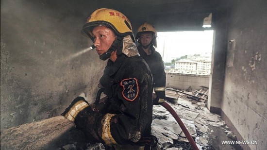 Firefighter Chen Jihang (front), a firefighter serving in Tongjiaqiao Fire Squadron, takes part in his first mission in Chongqing, southwest China, Aug. 23, 2013. 