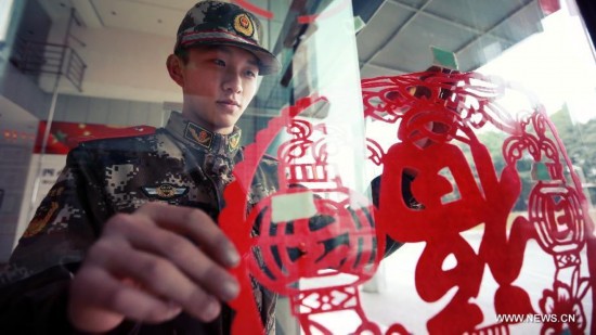 Firefighter Chen Jihang, a firefighter serving in Tongjiaqiao Fire Squadron, spends the Spring Festival in Chongqing, southwest China, Feb. 8, 2014. 