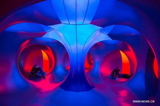 Festival goers rest in the colour lights of a Luminarium during the Sziget (Hungarian for 'Island') Festival on the Obuda Island in Budapest, Hungary on Aug. 16, 2014. The 22nd edition of the Sziget Festival lasts from August 11 to August 17.