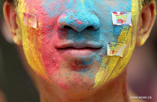 A citizen is seen during a color run activity in Heping District of Shenyang, northeast China's Liaoning Province, Aug. 16, 2014. 