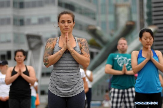 People take part in the 2014 Yogathon in Vancouver, Canada, Aug. 16, 2014.