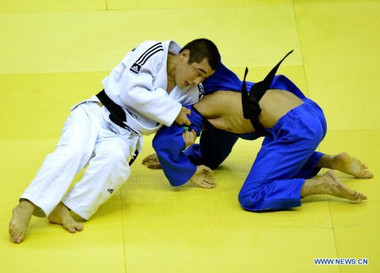 Bauyrzhan Zhauyntayev(Top) of Kazakhstan competes with Natig Gurbanli of Azerbaijan during Men -55 kg of Judo event of Nanjing 2014 Youth Olympic Games