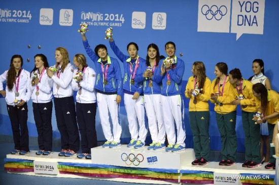 Team Great Britain(L), team China(C) and team Australia stand on the podium during the awarding ceremony of the women's 4 × 100m medley relay match of swimming event at the 2014 Nanjing Youth Olympic Games