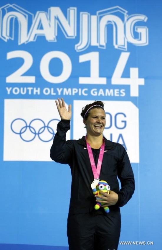 Clara Smiddy(C)of United States of American poses on the podium during the Women's 100m Backstroke match at Nanjing 2014 Youth Olympic Games