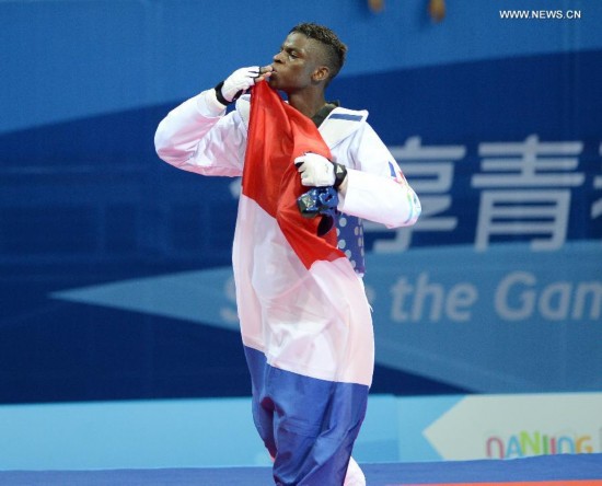 Yoann Miangue of France celebrates after the men+73kg final of Taekwondo event during Nanjing 2014 Youth Olympic Games in Nanjing, capital of east China’s Jiangsu Province, on Aug. 21, 2014.